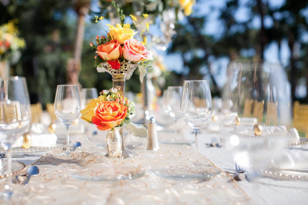 elegant wedding reception table details with coral and yellow florals at Powel Crosley Estate Sarasota