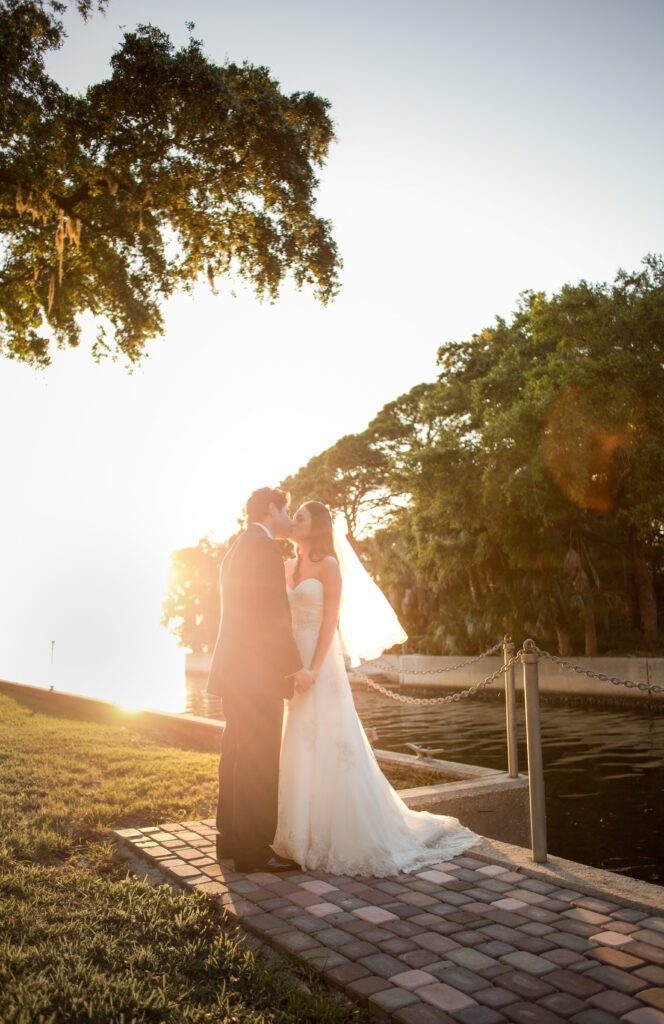 Bride and Groom kissing in the golden light at Powel Crosley Estate Sarasota wedding venue