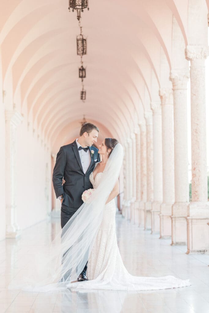 Romantic bride and groom portrait beneath the coral arches at The Ringling Museum in Sarasota Florida