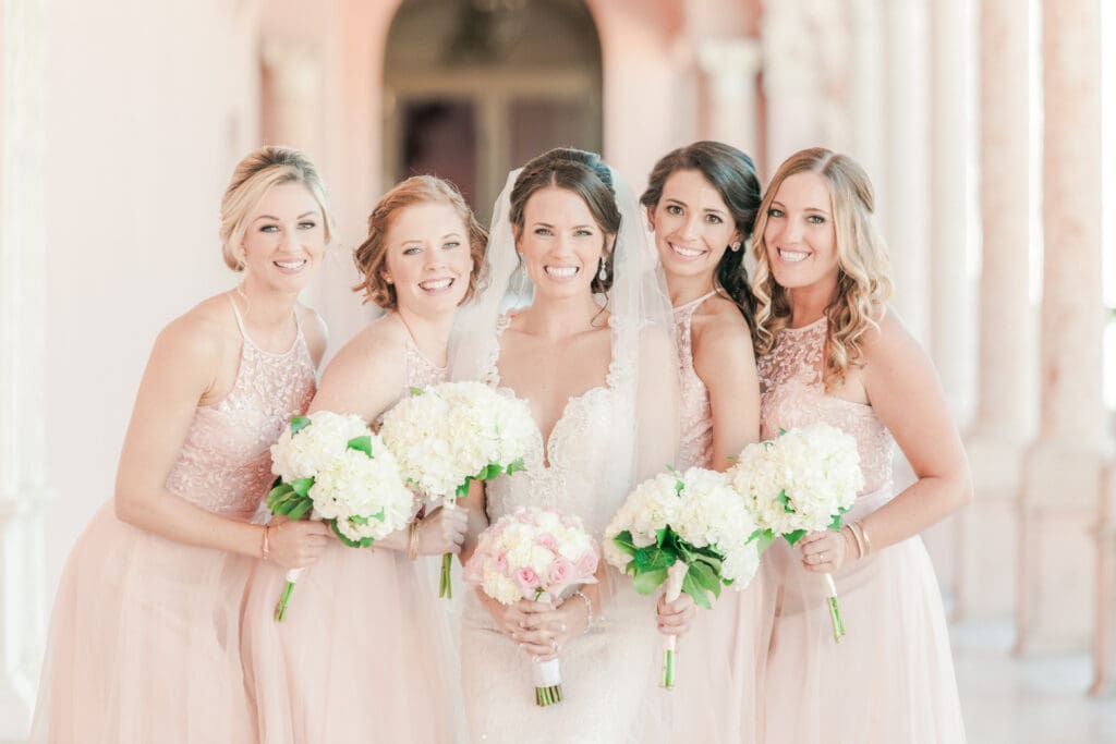 Bride and bridesmaids portrait in soft peach dresses at The Ringling Museum Sarasota Florida