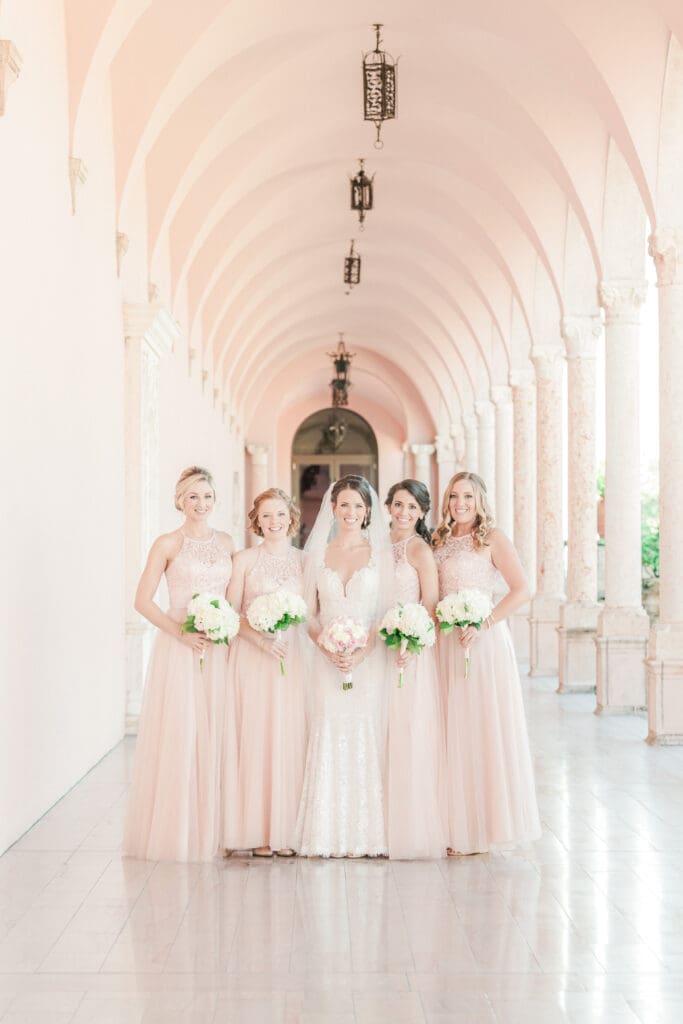Bridal party portraits beneath the historic arches at The Ringling Museum courtyard in Sarasota Florida