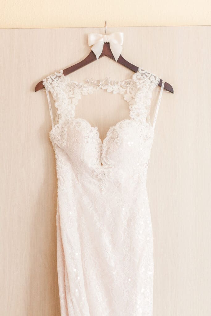 Elegant lace wedding dress hanging before the ceremony at The Ringling Museum Sarasota Florida