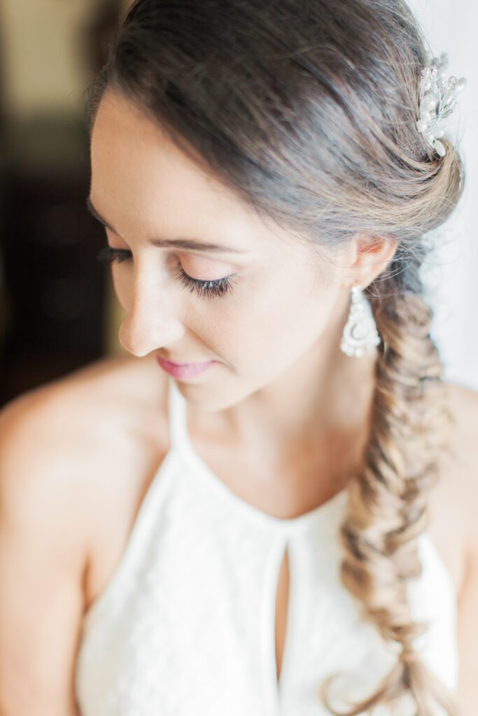 Close-up bridal portrait with soft natural light and braided hairstyle