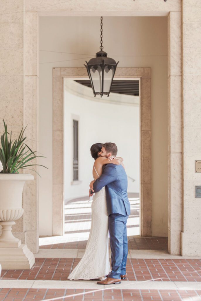Bride and groom embracing under archway at Museum of Fine Arts St. Petersburg