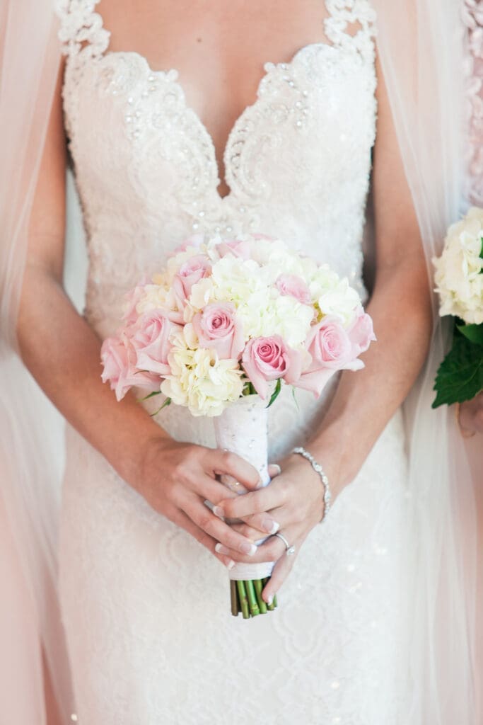 Bride holding a blush and ivory wedding bouquet during a refined Ringling Museum wedding in Sarasota