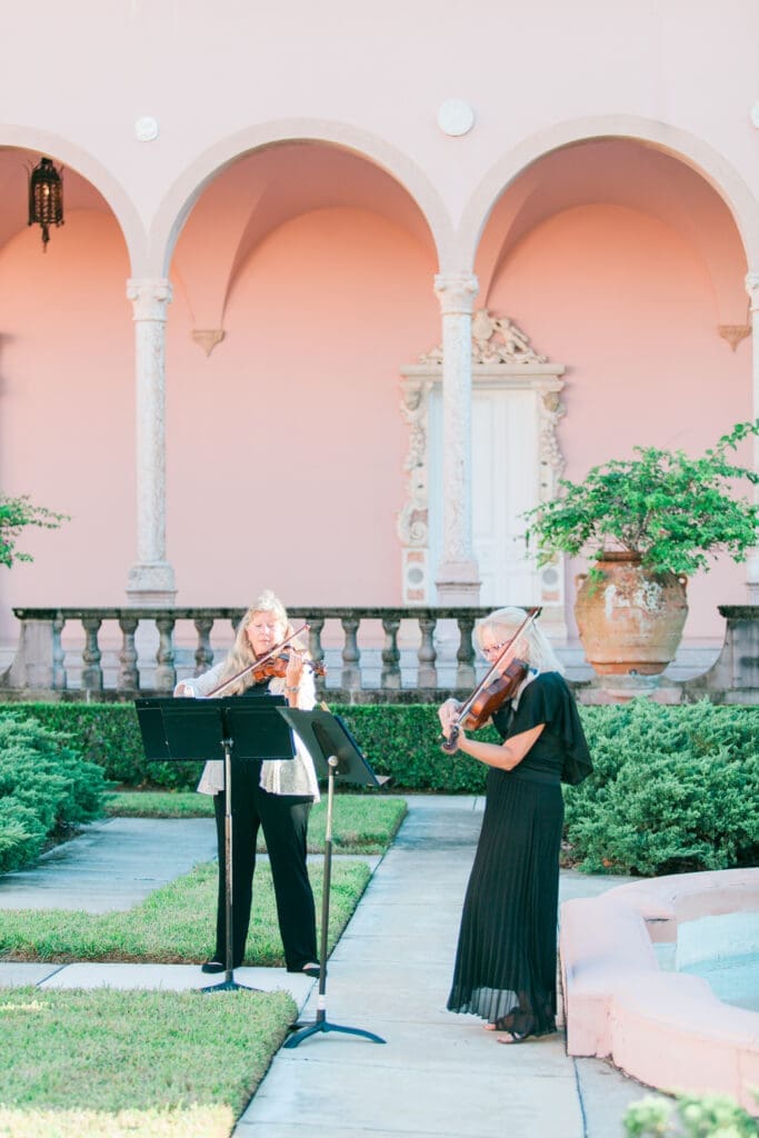 Live musicians performing during an outdoor courtyard wedding ceremony at The Ringling Museum