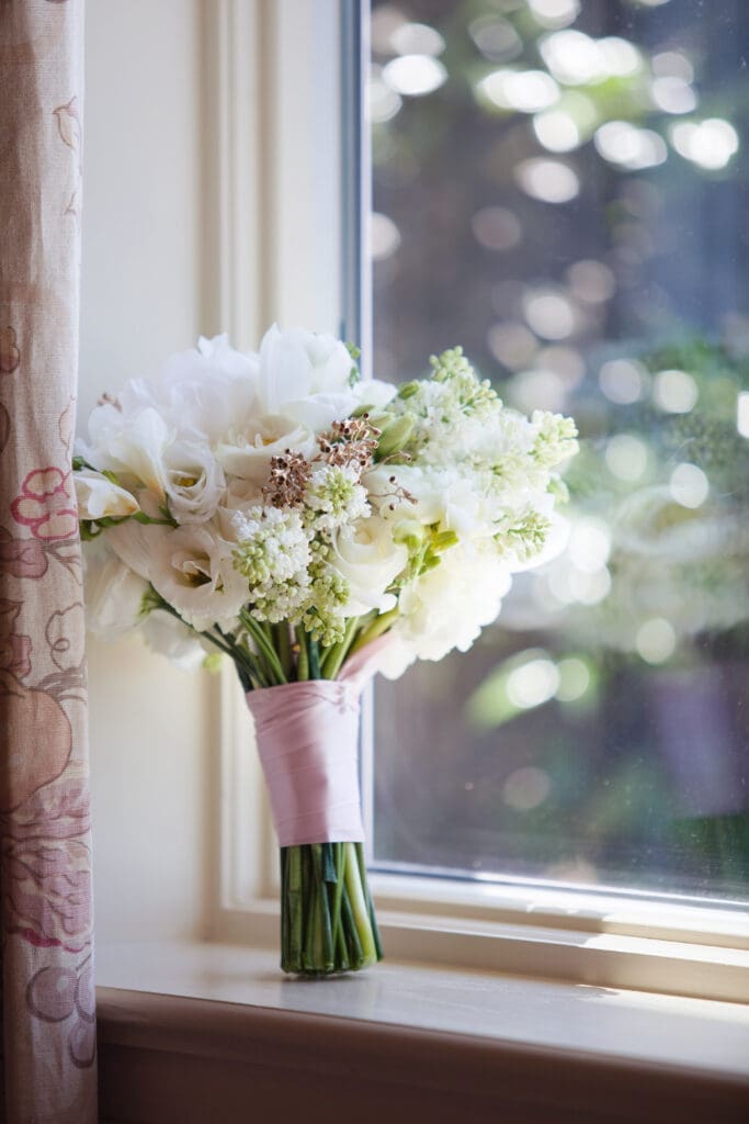 Bridal bouquet beside a window during wedding morning at Colleton River Club