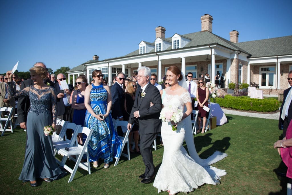 Bride walking down aisle during Southern coastal wedding ceremony