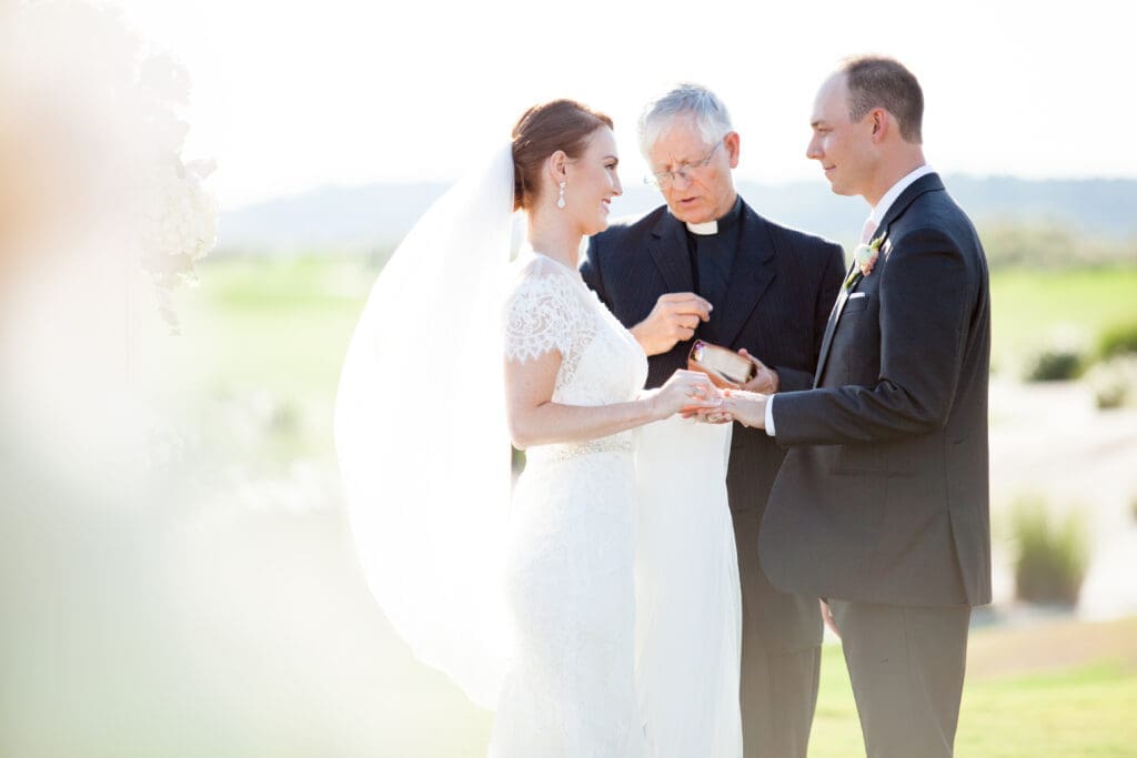 Bride and groom portrait with veil and soft evening sunlight