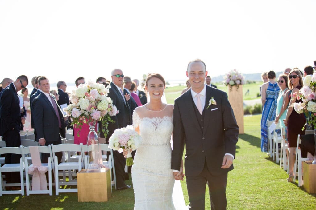 Bride and groom walking down aisle after wedding ceremony