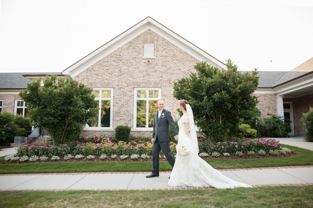 Bride and groom walking outside Colleton River Club wedding venue