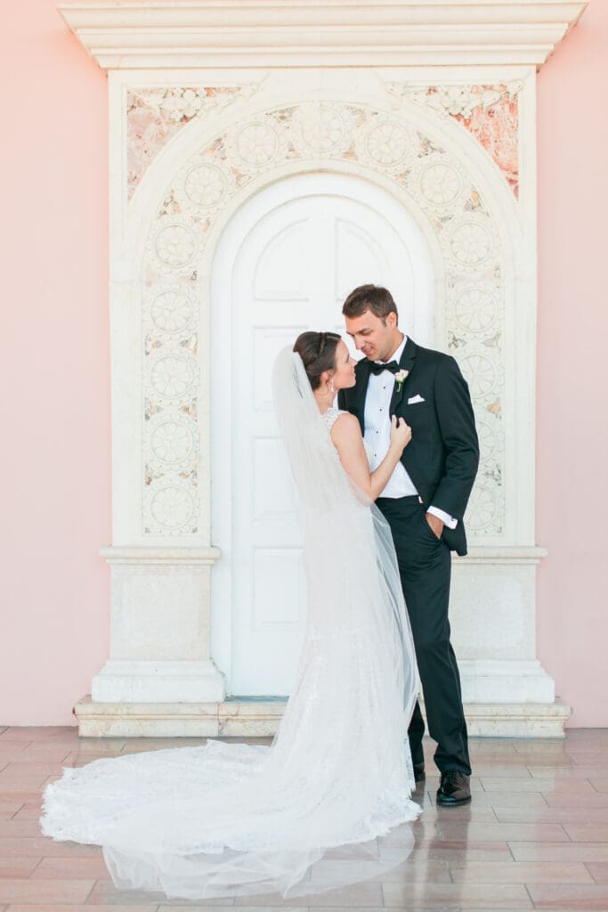 Romantic bride and groom portrait beneath the coral arches at The Ringling Museum in Sarasota Florida